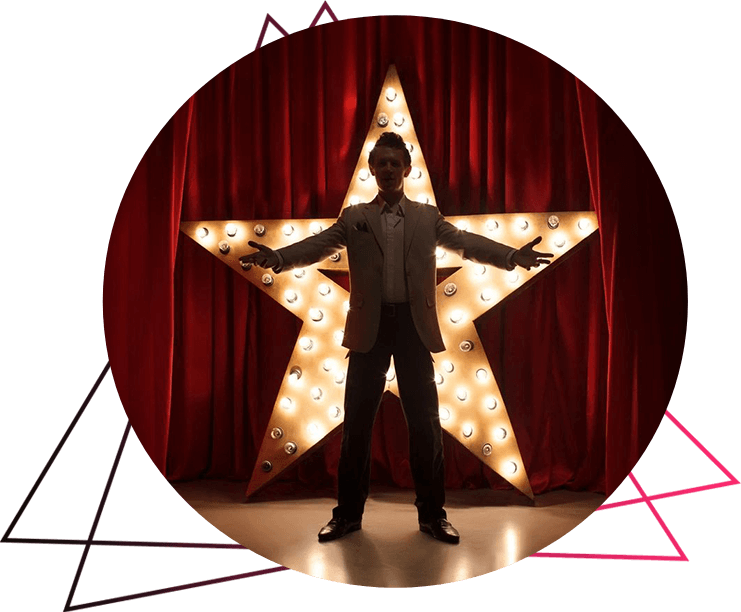 A man standing in front of a star on stage.