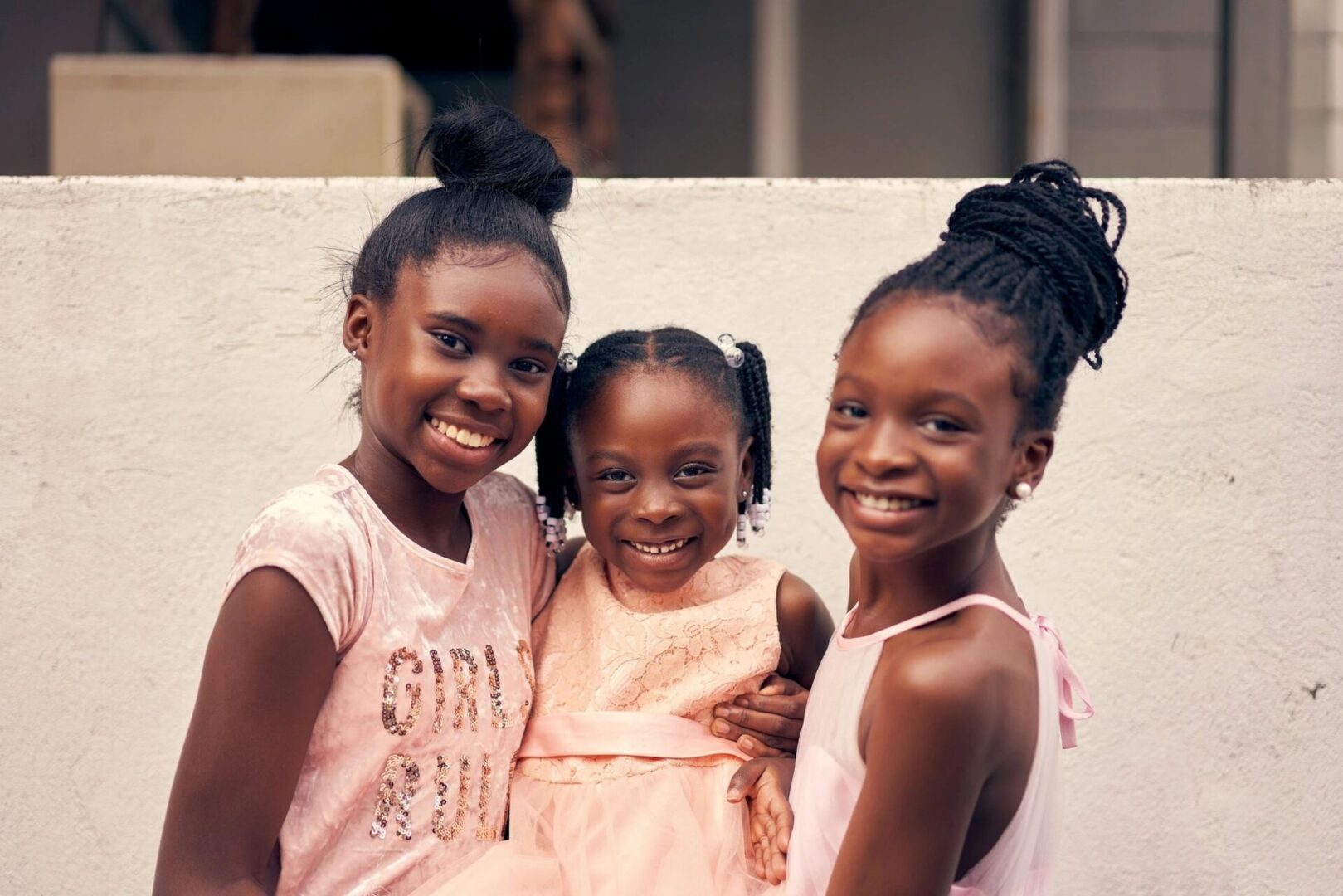 Three young girls posing for a picture.